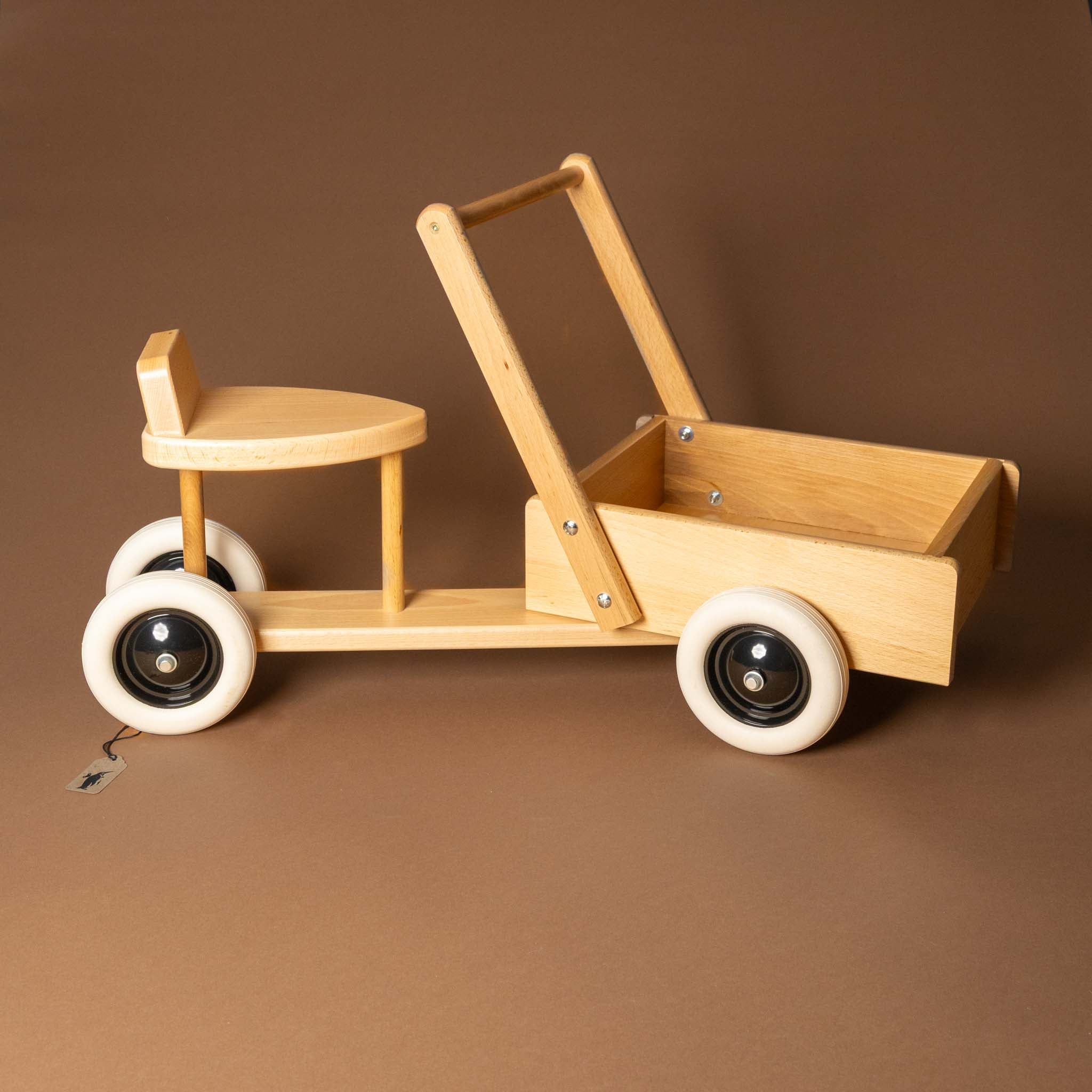 wooden-sit-and-ride-with-cargo-box Wooden toy with a seat and pull handle on a brown background