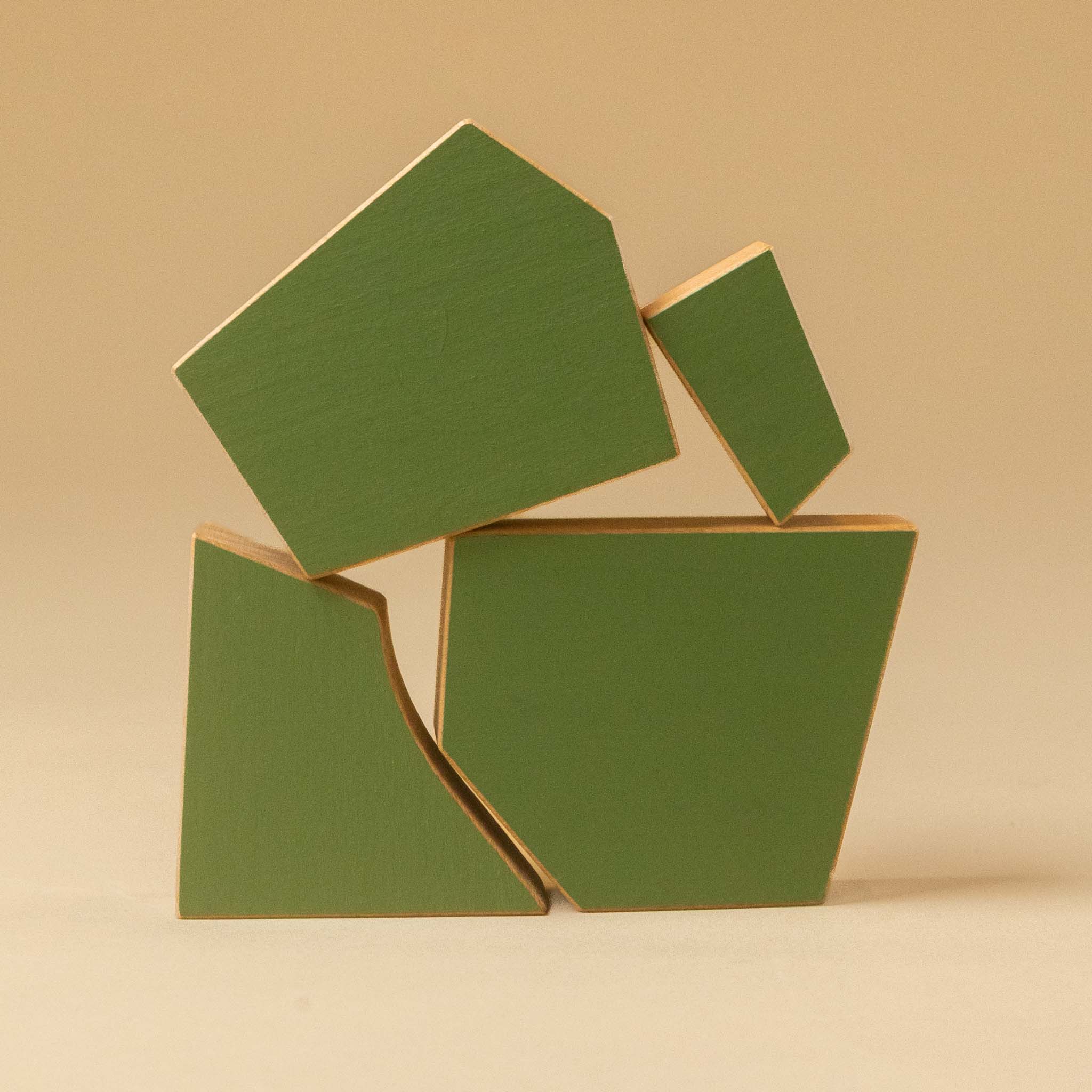 Three green geometric wooden-tree-poplar with natural wood edges, arranged on a warm beige background.