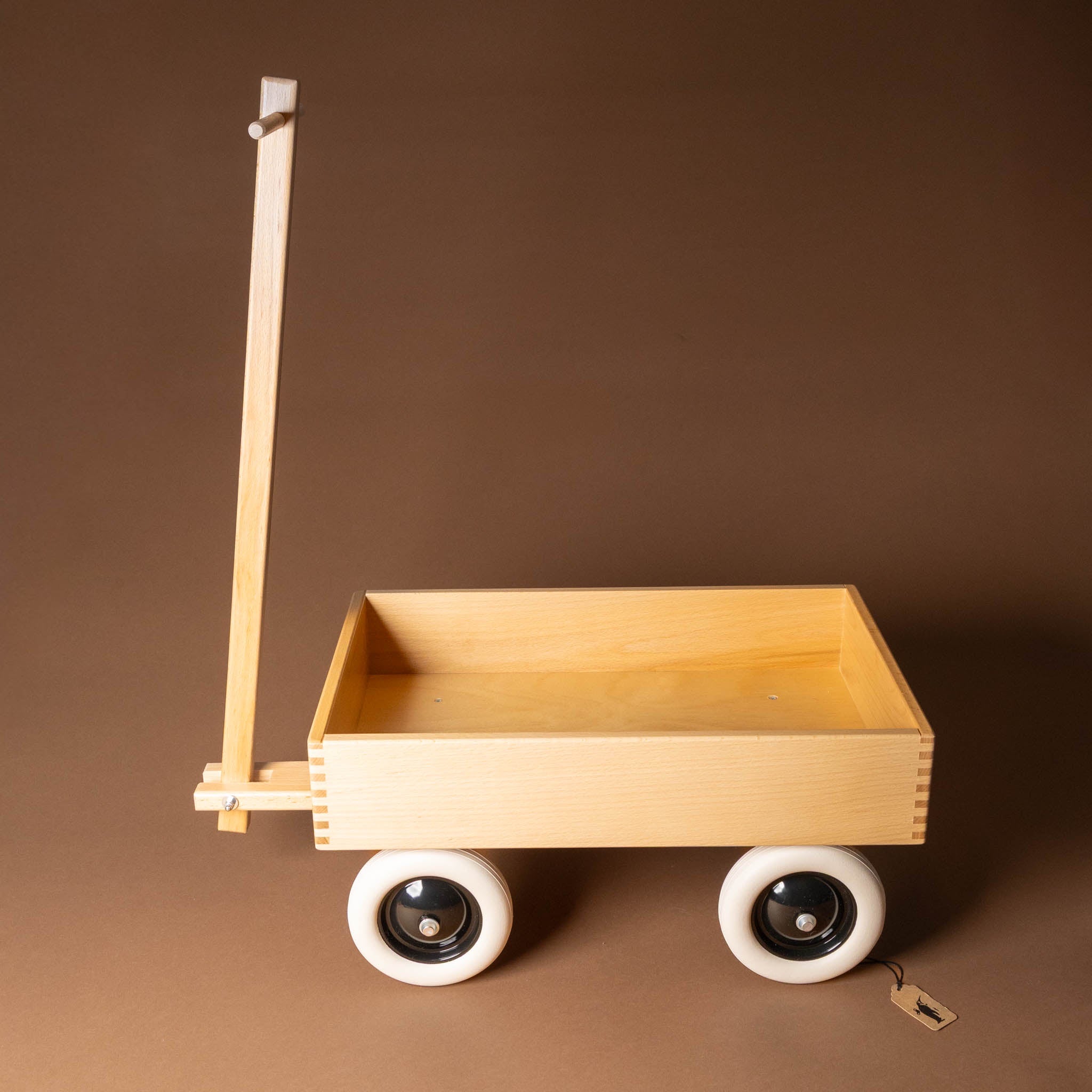 wooden-wagon with white wheels on a brown background