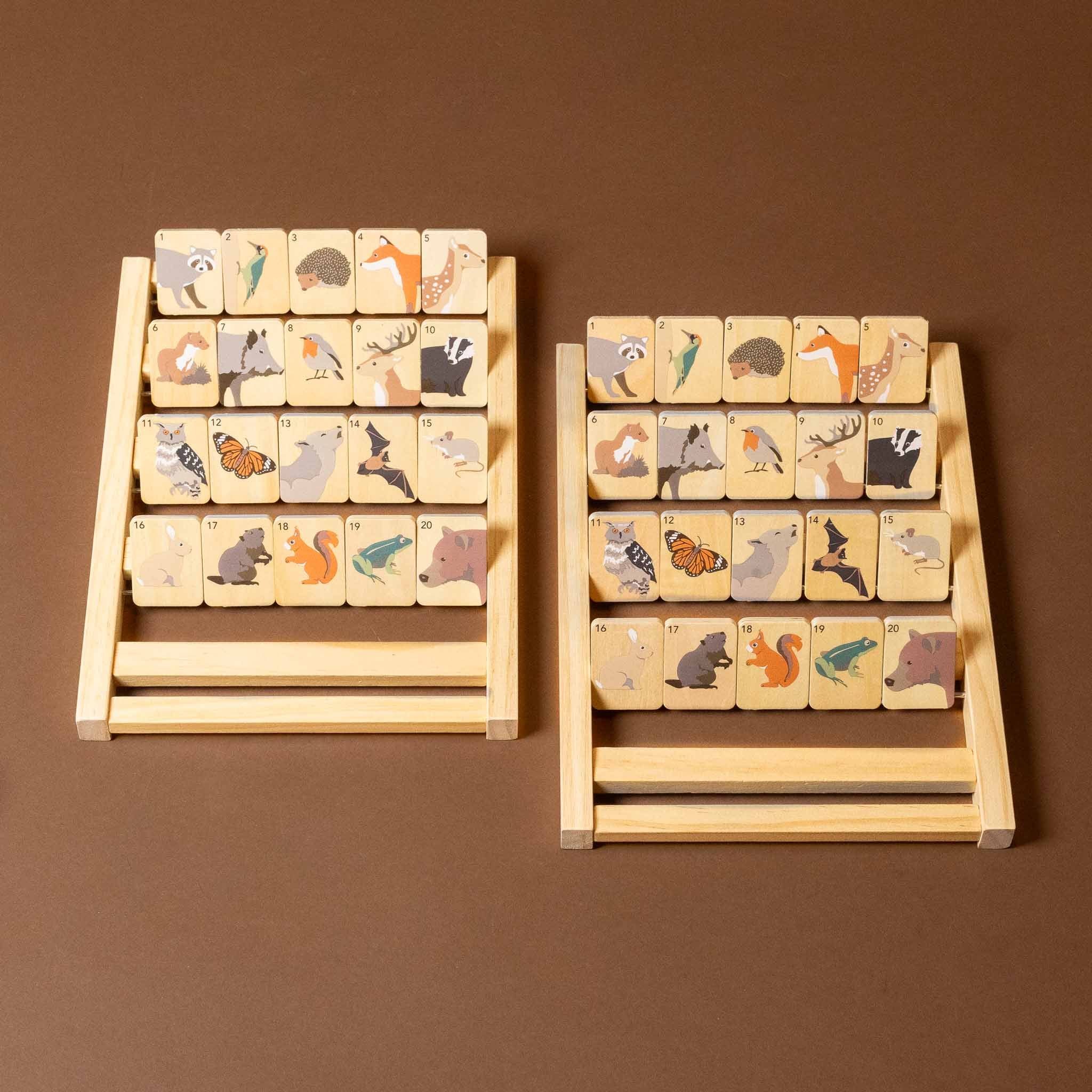 Two wooden wooden-who-am-i-game sets with animal illustrations on a brown background