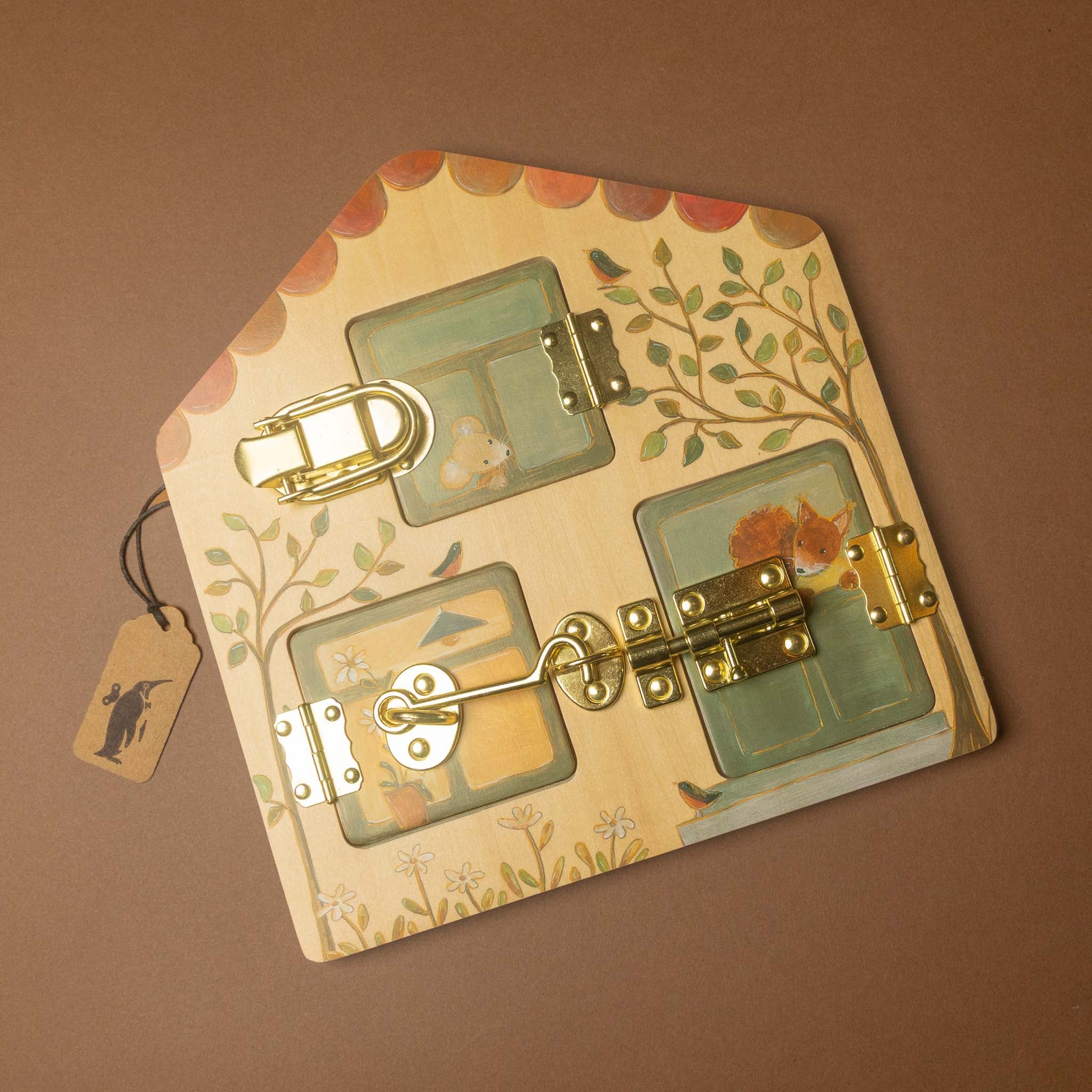 woodland-friends-latches-house activity board with three small window panels, brass latches, and painted floral and bird details, shown on a brown background with a hanging tag.