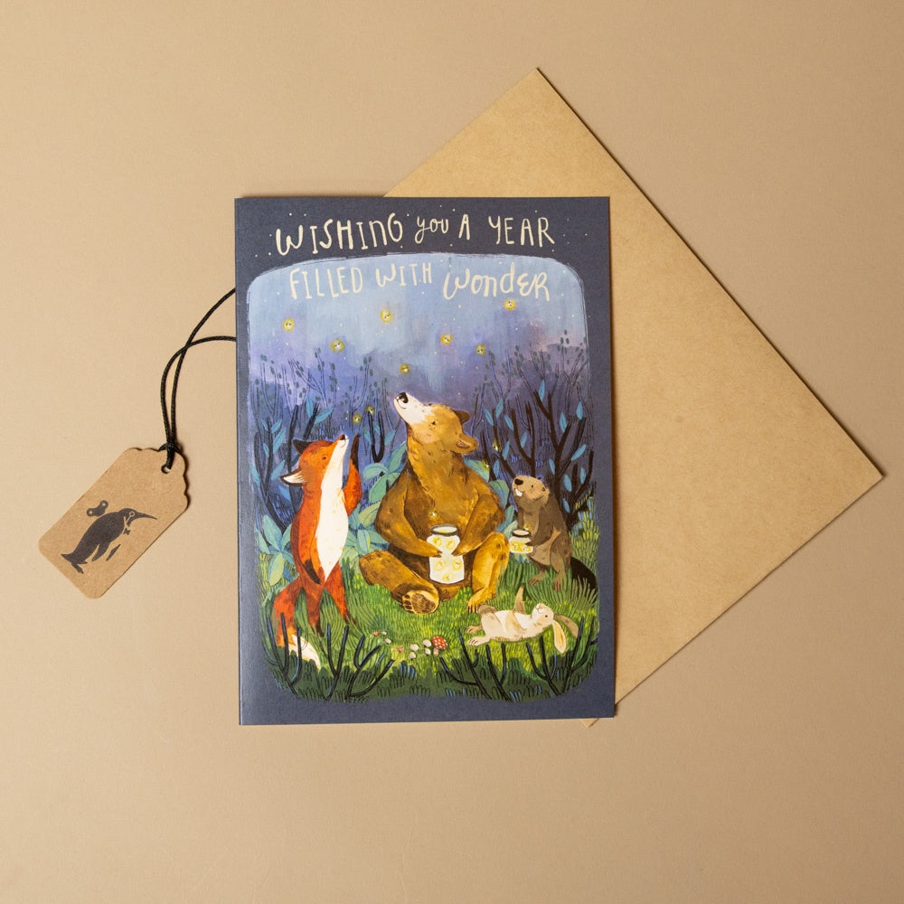 woodland-wonder-birthday-greeting-card--1 with illustration of animals and 'Wishing you a year filled with wonder' text, placed on a beige background.