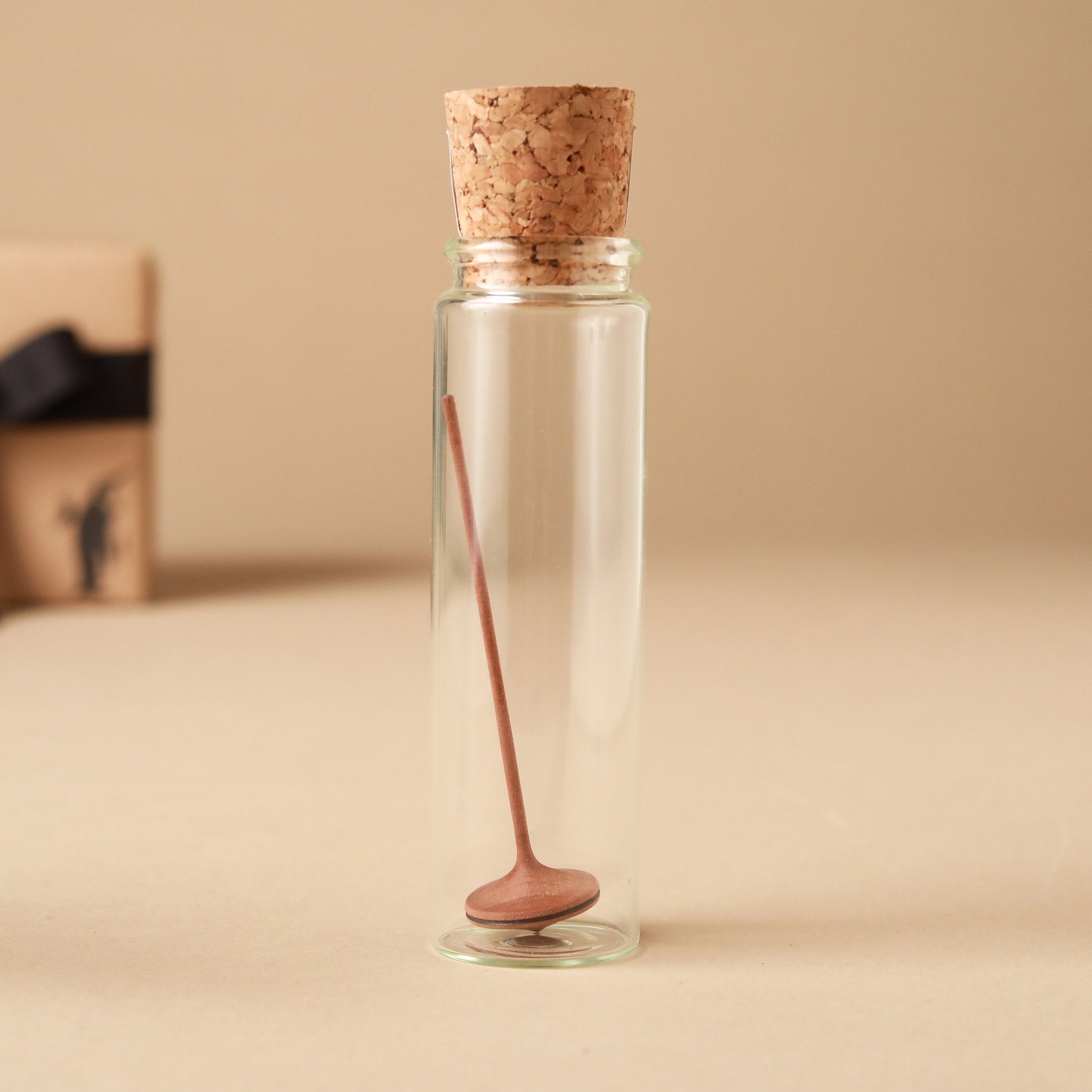 dark-wood-spinning-top-in-glass-jar