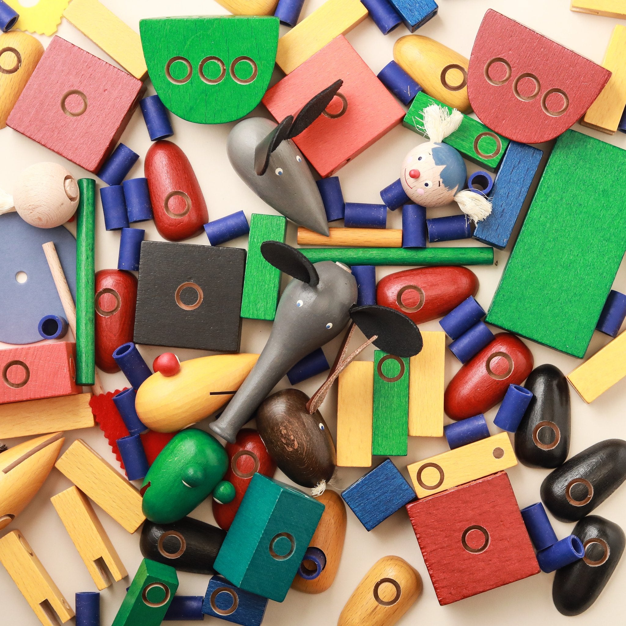 close-up-colorful-wooden-pieces-in-building-set-of-rollicking-family-steck-figure-set