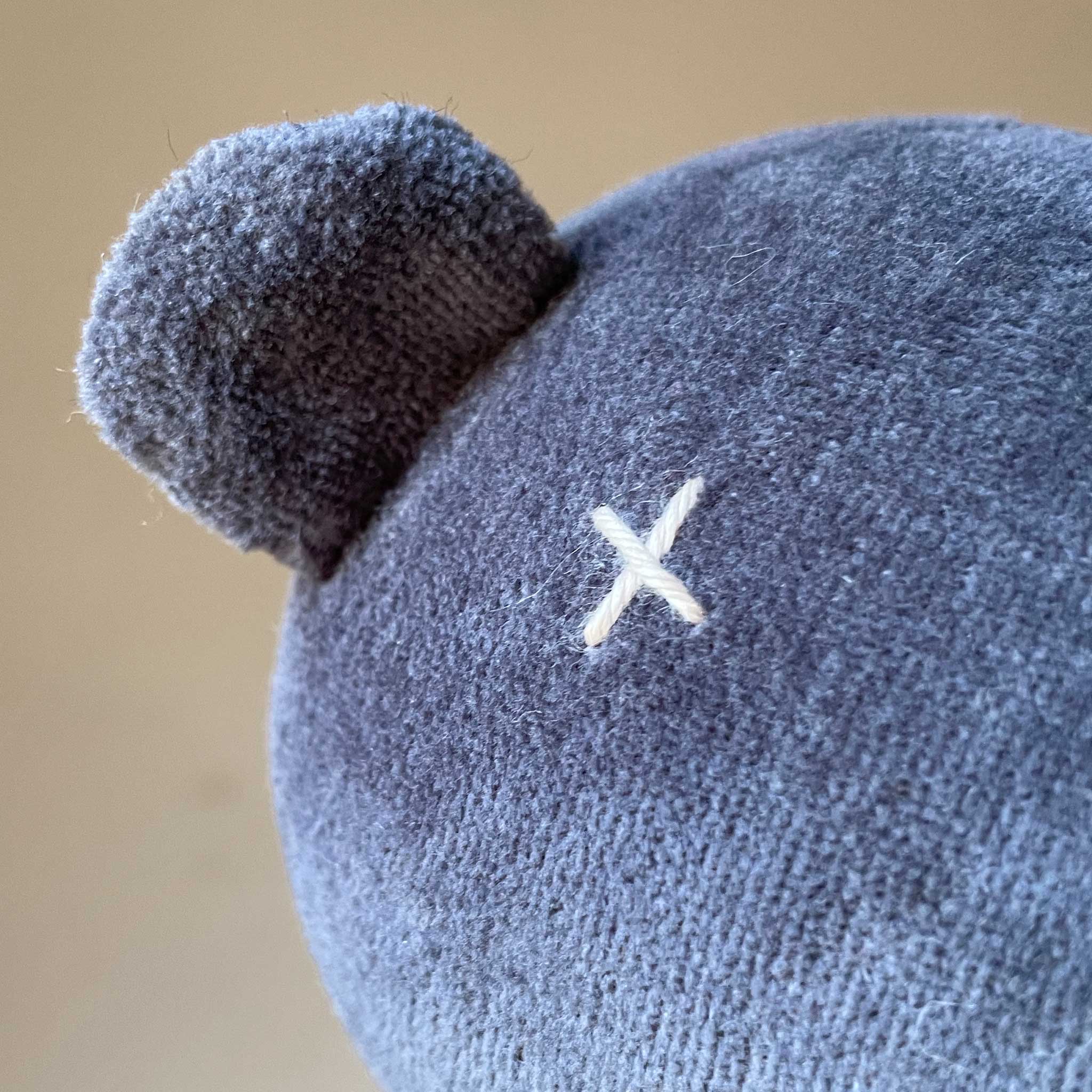 detail-of-stitched-cross-eye-and-little-ears