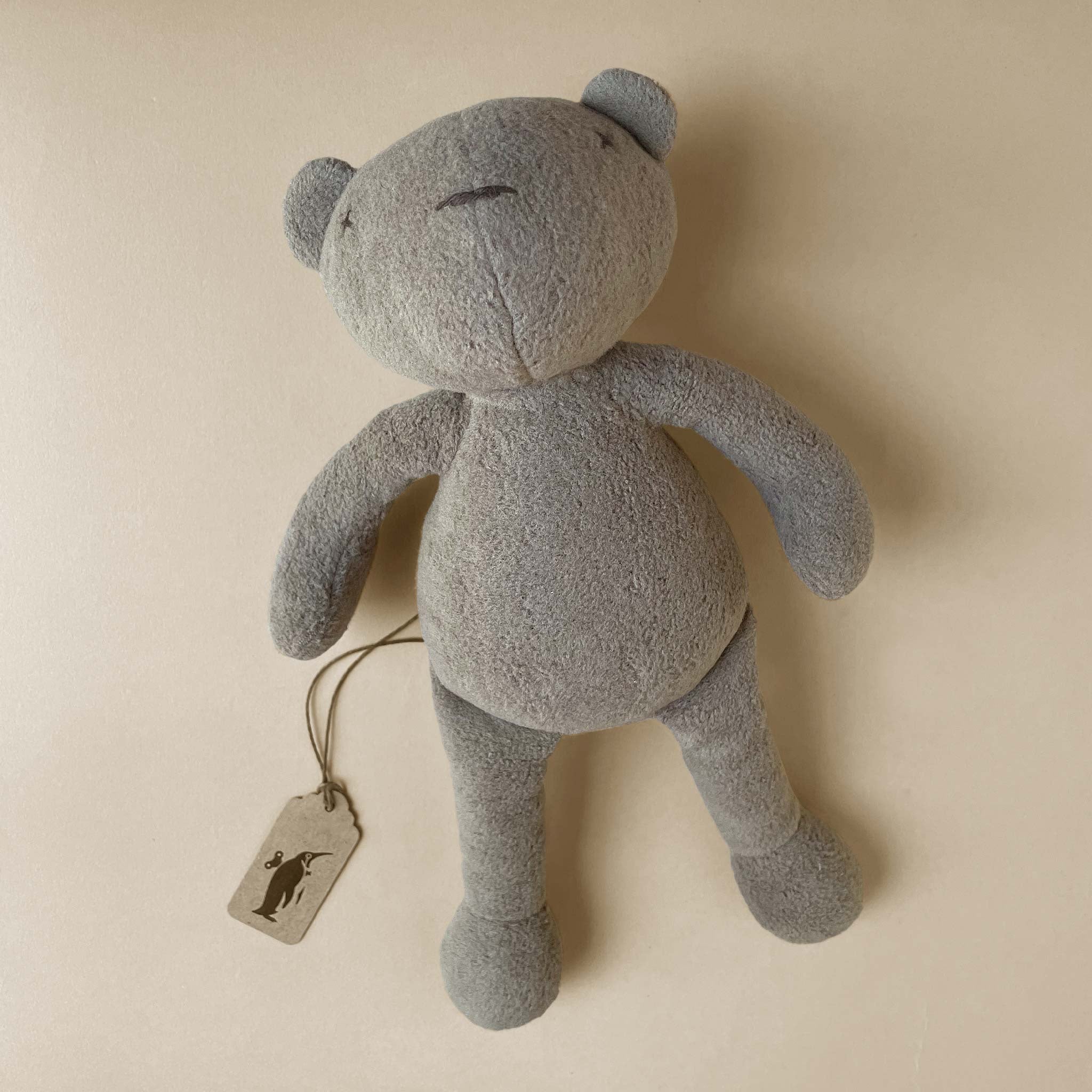 grey-bear-plush-laid-on-back