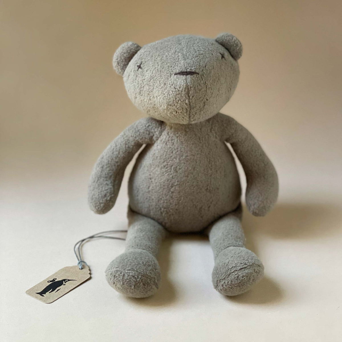 grey-plush-bear-with-stitched-details-sitting-up