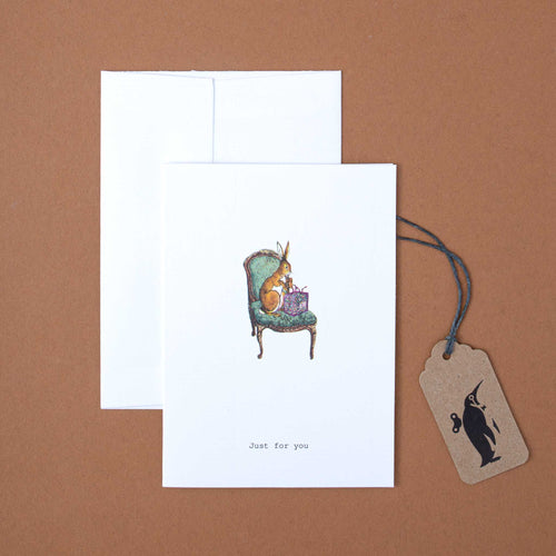 white-greeting-card-illustrated-rabbit-in-green-armchair-and-black-text-reading-just-for-you