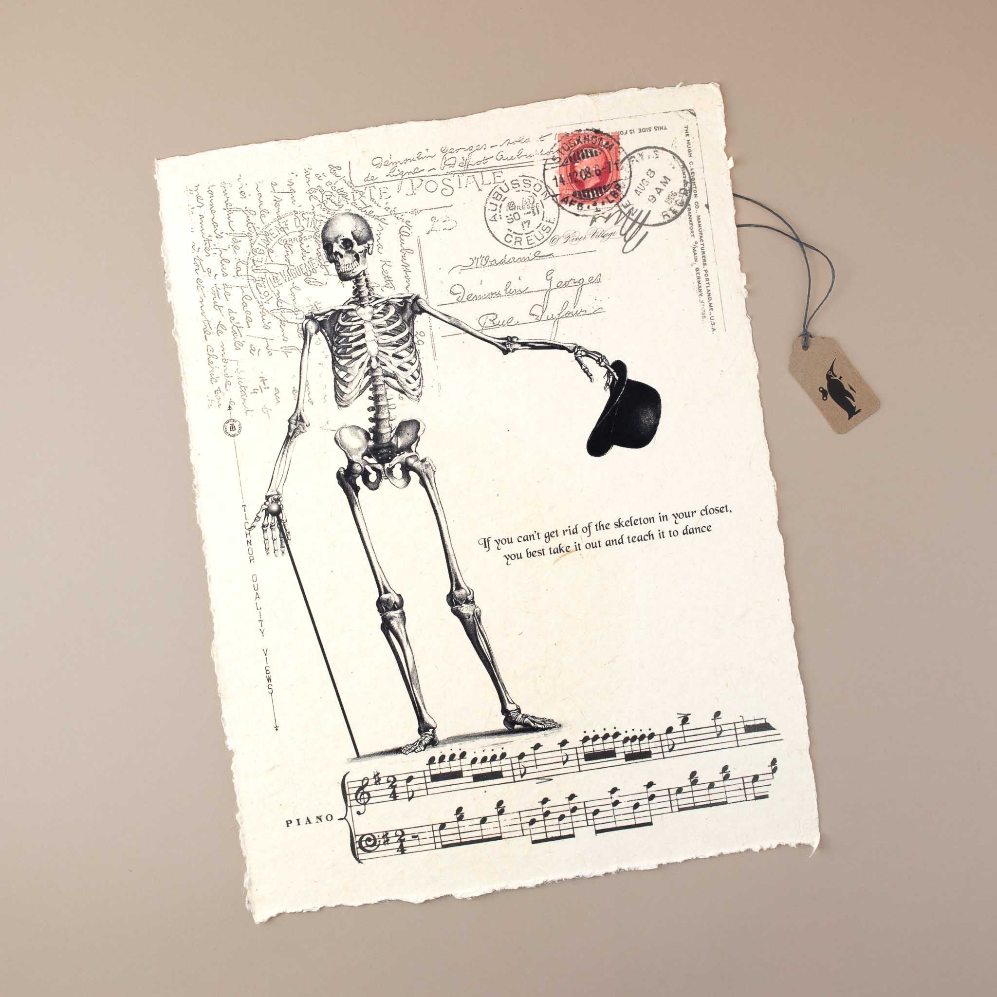 handmade-white-paper-with-skeleton-print-holding-a-stick-and-hat