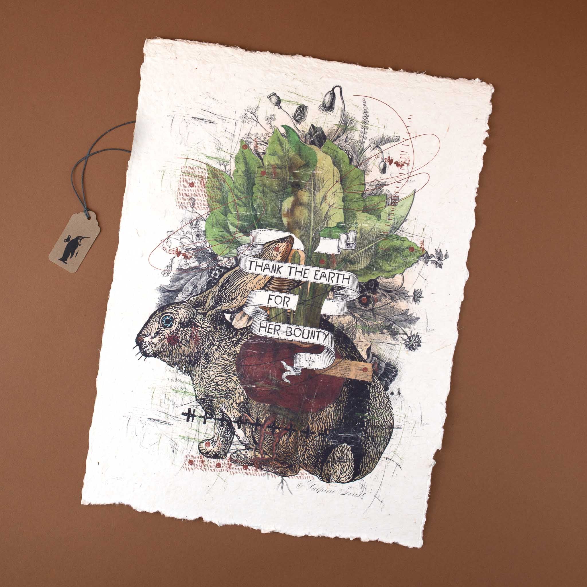 Paper print with hare illustration and "Thank the Earth for her Bounty" inscription.