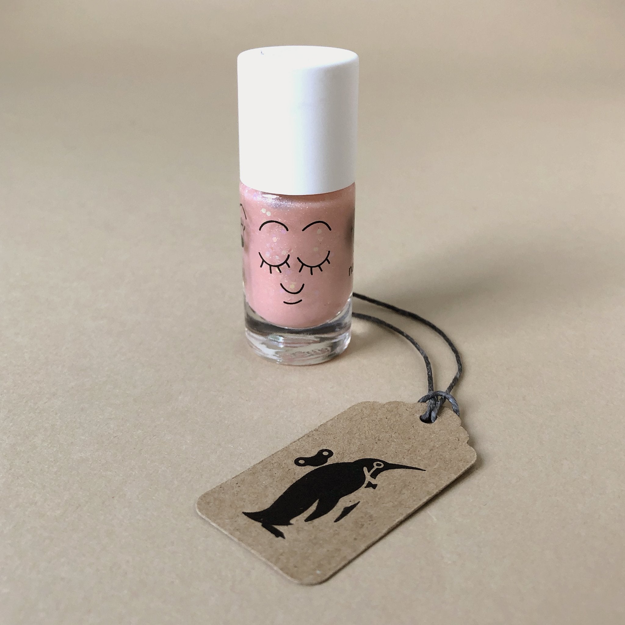 peach-sparkly-nail-polish-in-bottle-with-sleeping-face