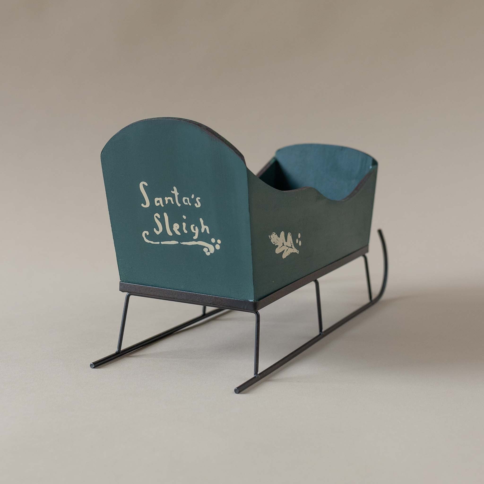 back-view-of-large-forest-sleigh-with-santa's sleigh-in-ivory-lettering