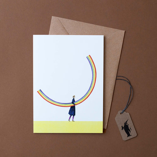 girl-holding-rainbow-on-white-background-with-craft-paper-envelope
