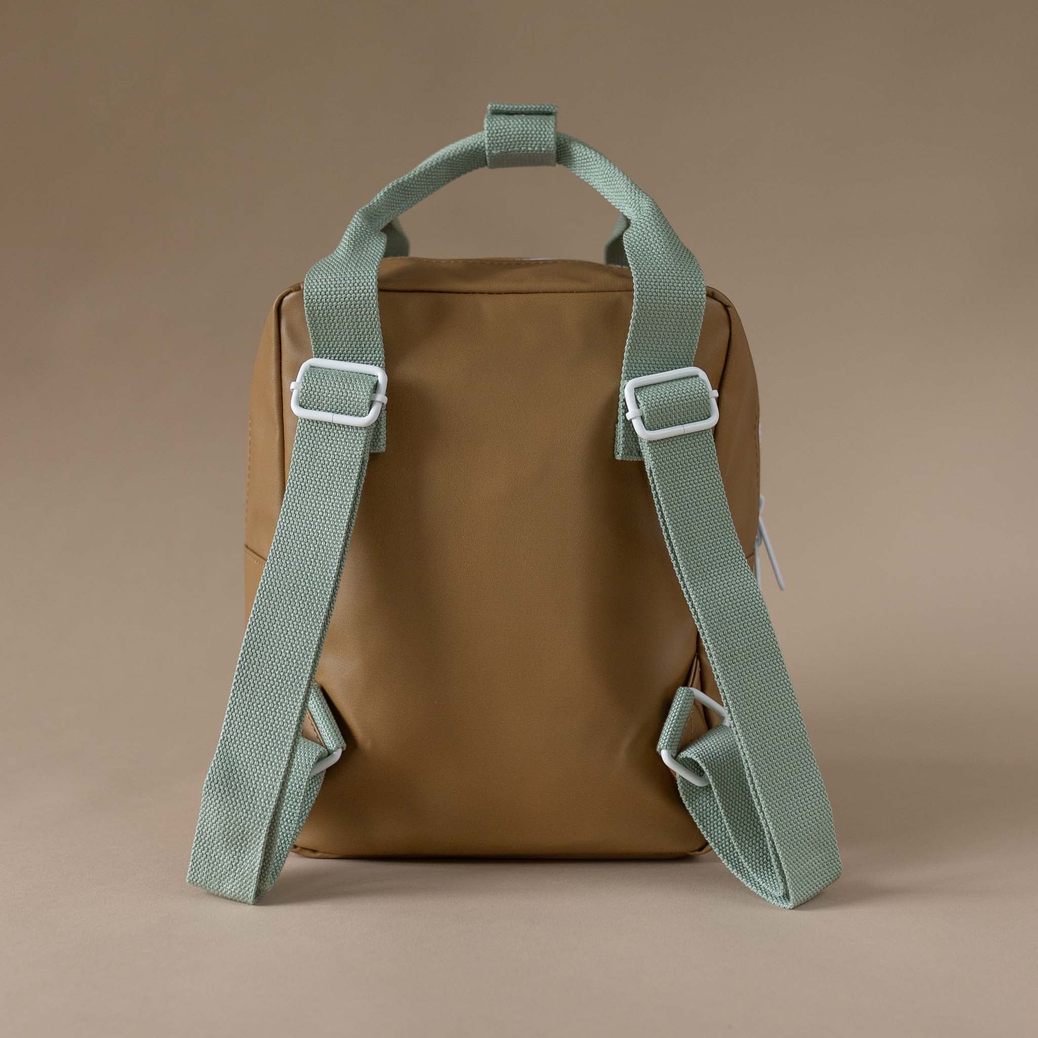 back-view-khaki-backpack-and-green-straps