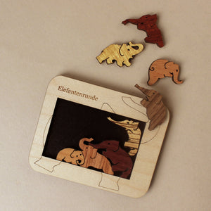 wooden-elephants-puzzle-in-light-wood-frame
