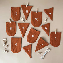 Load image into Gallery viewer, woodland-advent-calendar-rust-brown-cotton-pockets-numbered-with-clothespins-and-string-to-hang-up