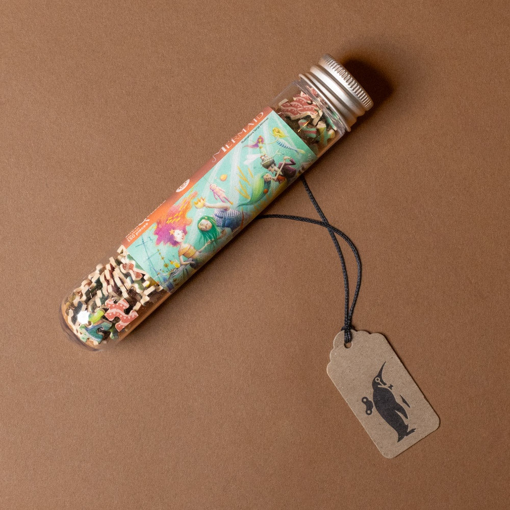 150-piece-micro-puzzle-my-mermaid Decorative tube with colorful design and a tag on a brown background