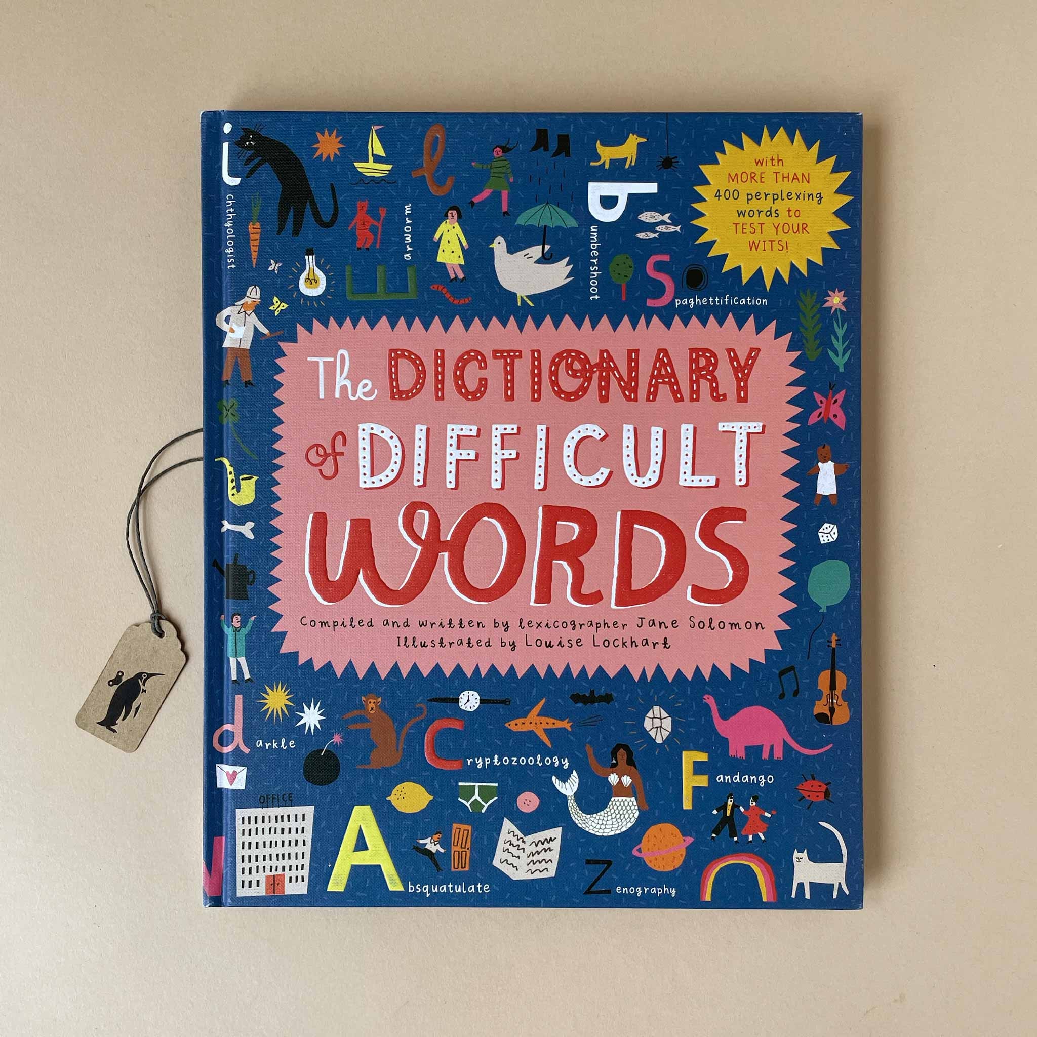 Book titled 'The Dictionary of Difficult Words' with colorful illustrations on a beige background