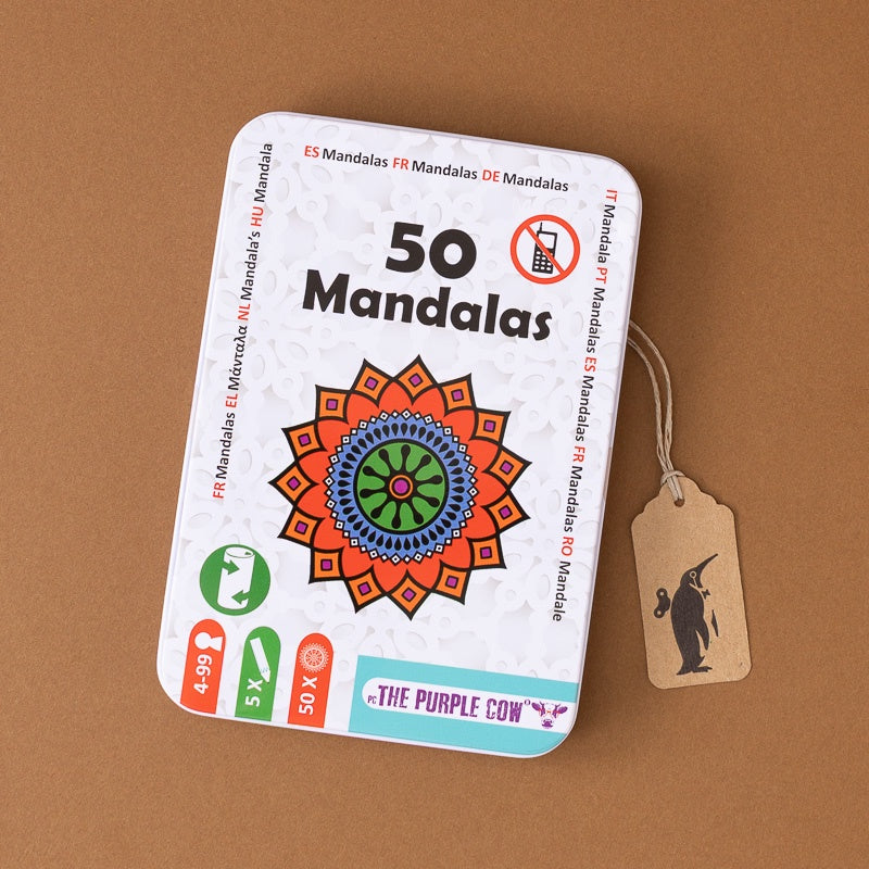 A white metal tin labeled '50 Mandalas' with a colorful mandala illustration on the front, shown on a brown background with a hanging kraft paper tag.