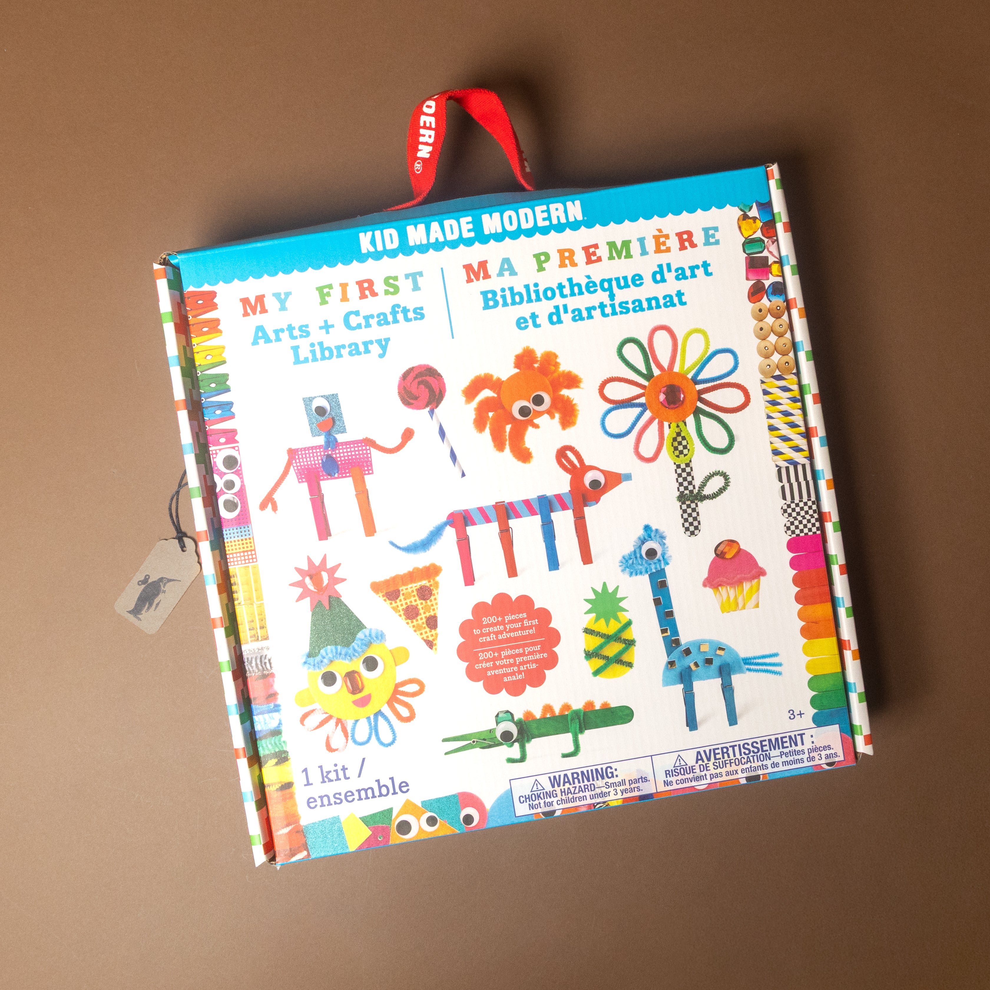 Colorful children's kit titled 'My First Arts & Crafts Library' by Kid Made Modern on a brown background.
