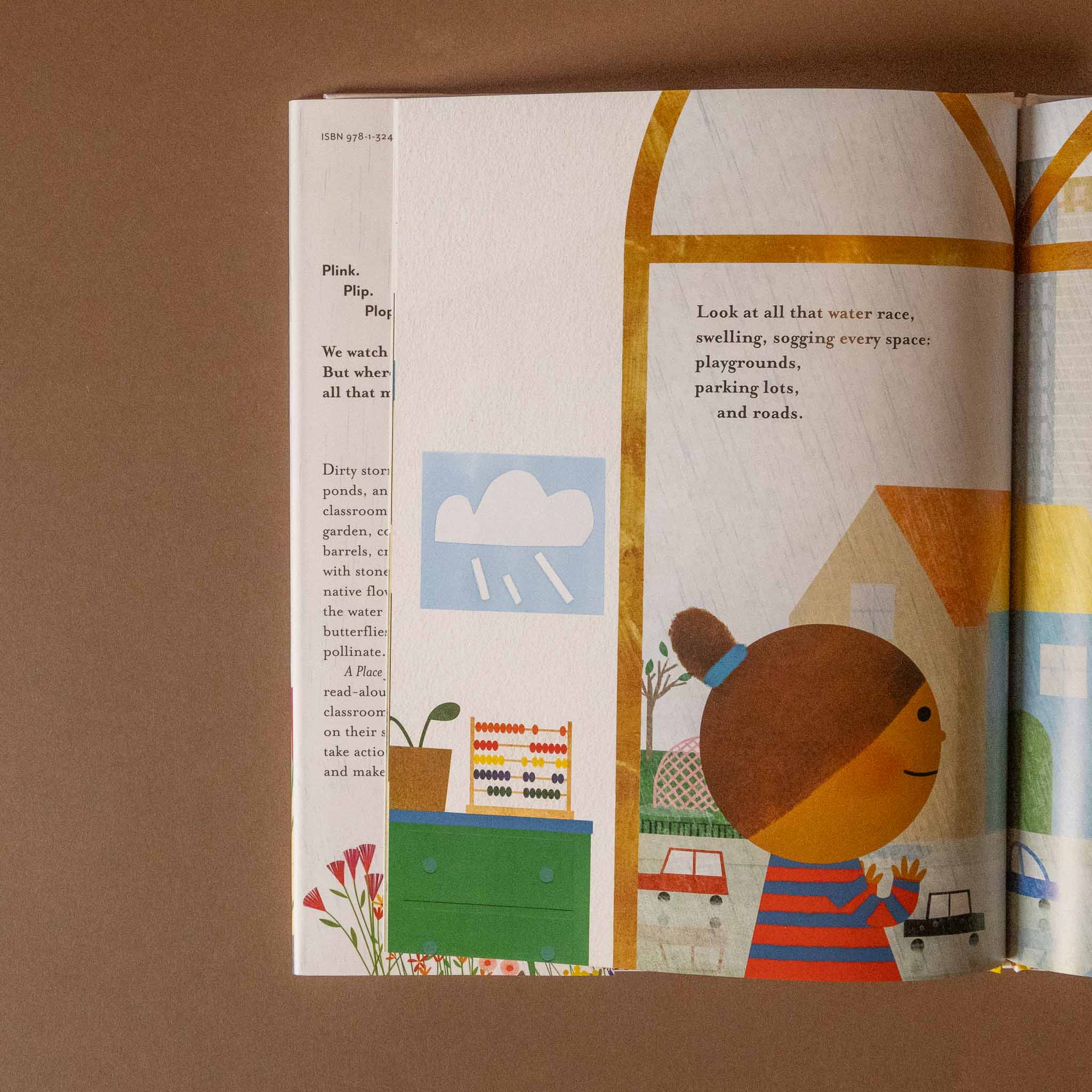 Open a-place-for-rain book with colorful illustrations and text on a brown background