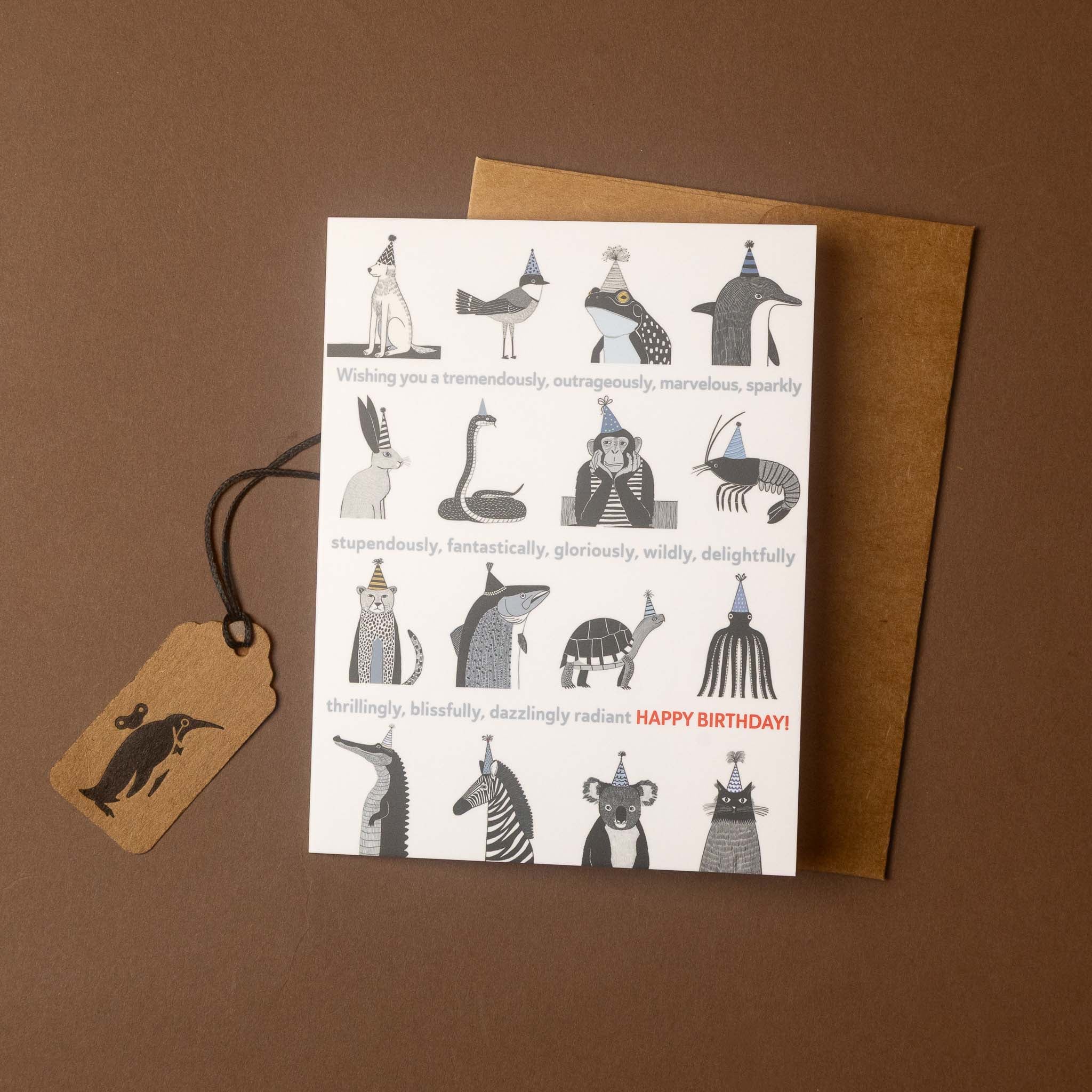 A white greeting card with illustrated animals wearing party hats and the text 'Wishing you a tremendously, outrageously, marvelously, sparkly. happy birthday
