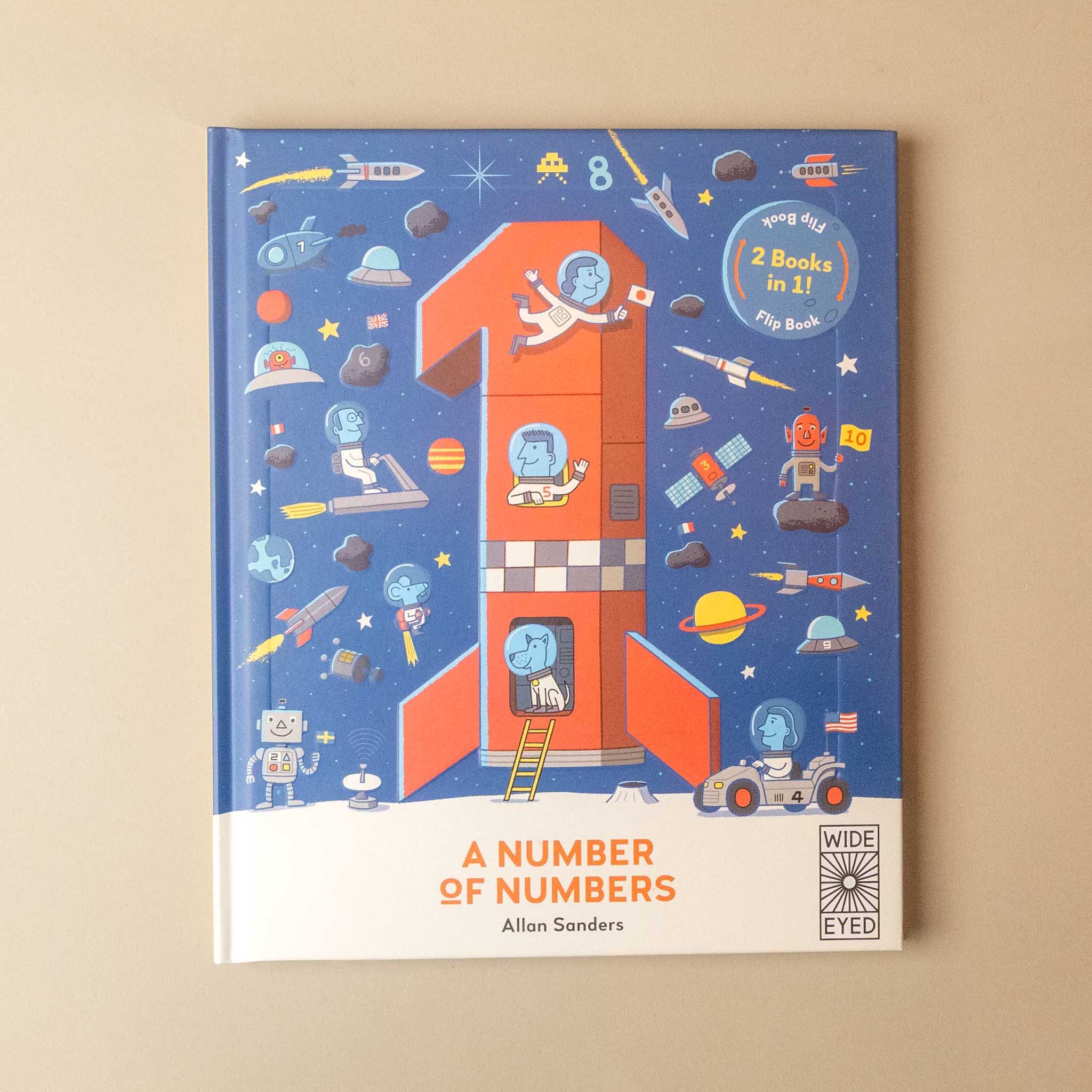A children's book titled 'A Number of Numbers' by Allan Sanders, featuring a colorful space-themed illustration on a blue cover with a large number one and a rocket ship, photographed on a beige background.