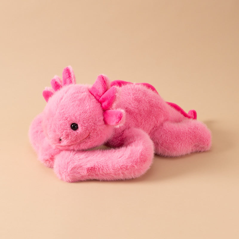 A pink andy-the-axolotyl-kiddo plush toy with a fuzzy, soft texture, featuring small black bead eyes