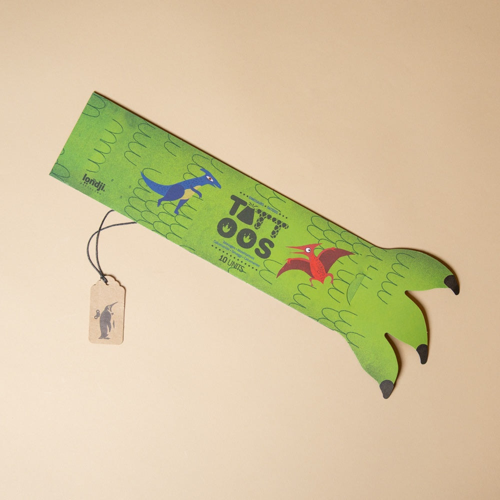 armful-of-tattoos-dinosaurs with dinosaur designs on a beige background