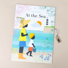 Load image into Gallery viewer, at-the-sea-book-cover-with-mother-and-son-walking-the-beach-with-a-lighthouse-in-distance