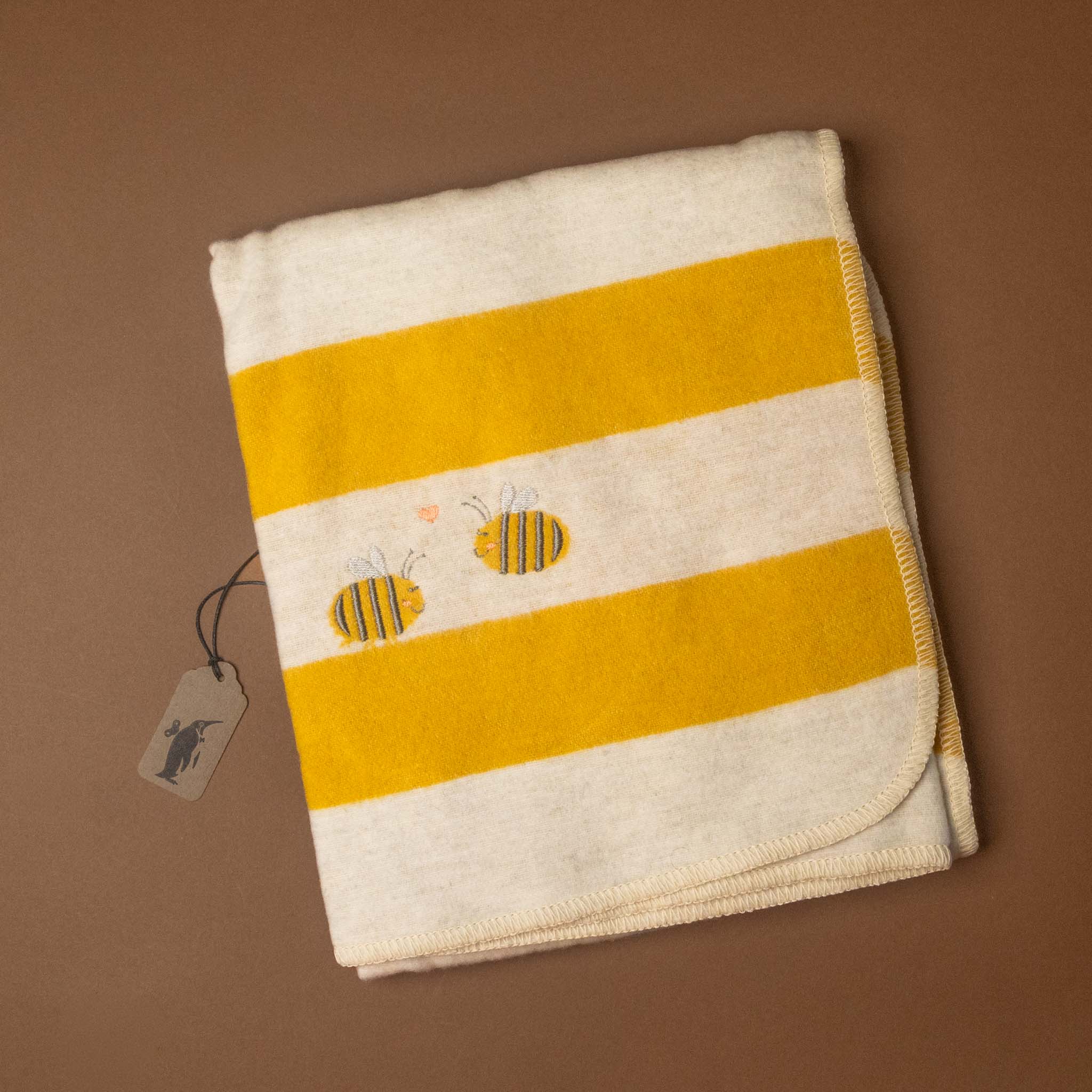 Striped baby-blanket-embroidered-bumblebee with bee designs on a brown background