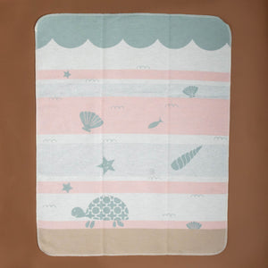 baby-blanket-pink-sage-white-sand-stripes-with-sage-turtle-seashells-fish-starfish-in-ocean-water-with-waves-and-sand-floor