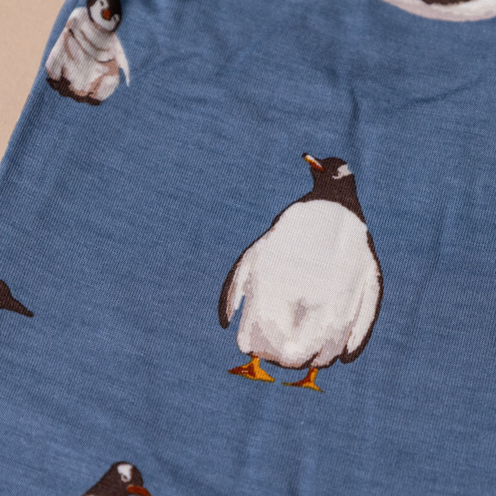 bamboo-zipper-pajamas-penguins Blue fabric with penguin pattern