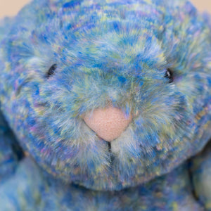 dappled-blue-green-yellow-purple-fur-with-pink-nose-of-stuffed-animal
