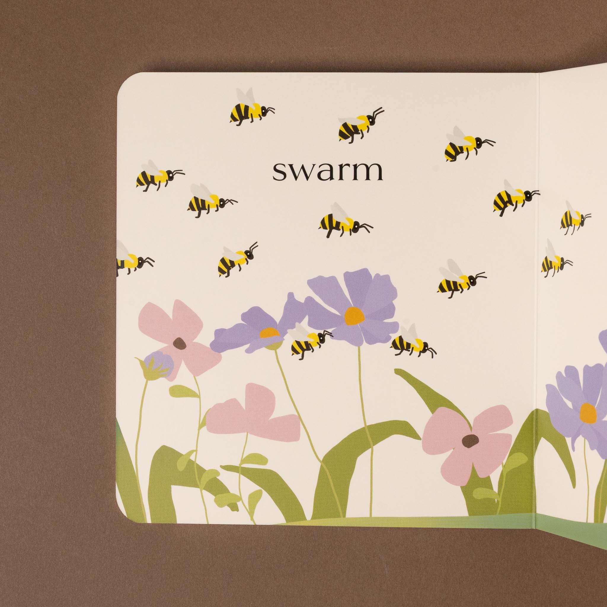 Children's beehive-board-book titled 'swarm' with illustrations of bees and flowers on a brown background