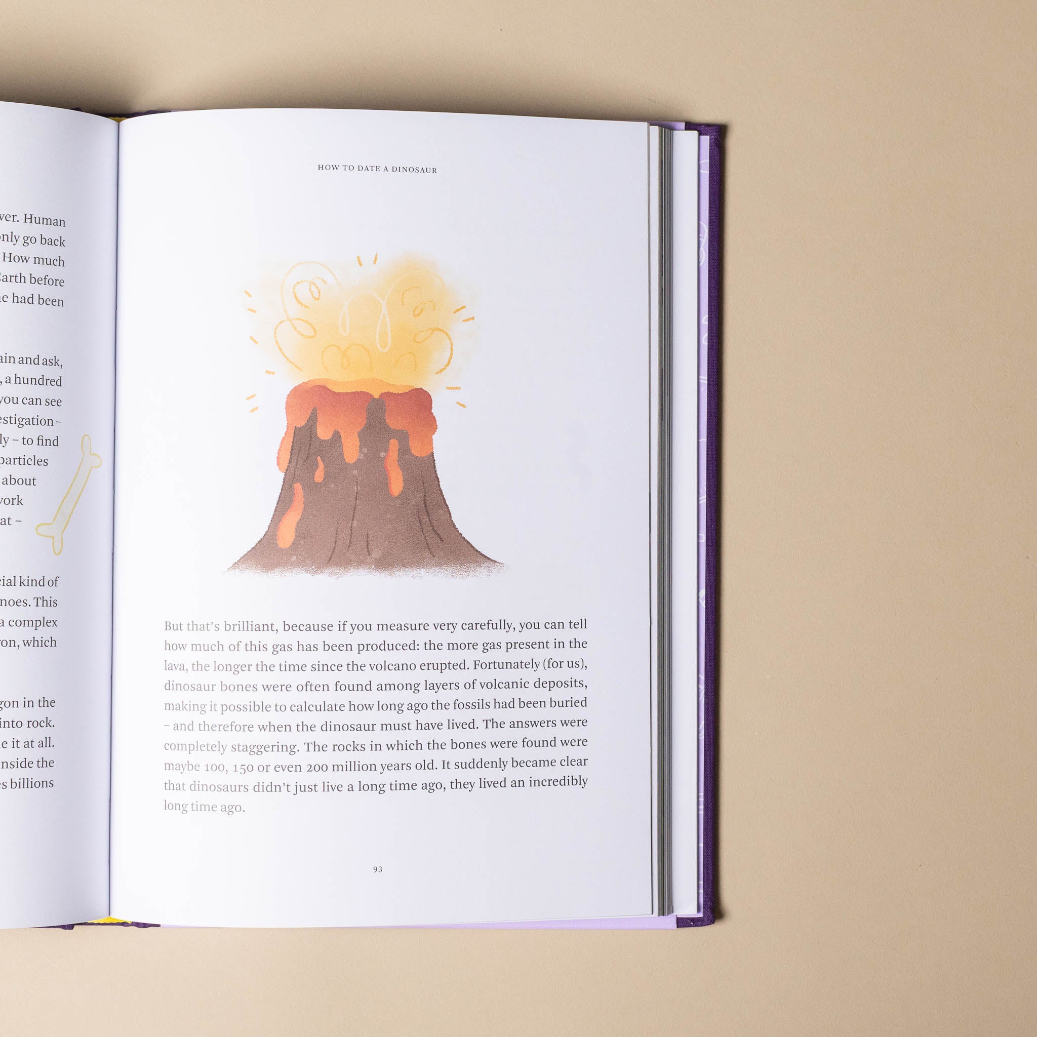 Open book with an illustration of a volcano on a beige background
