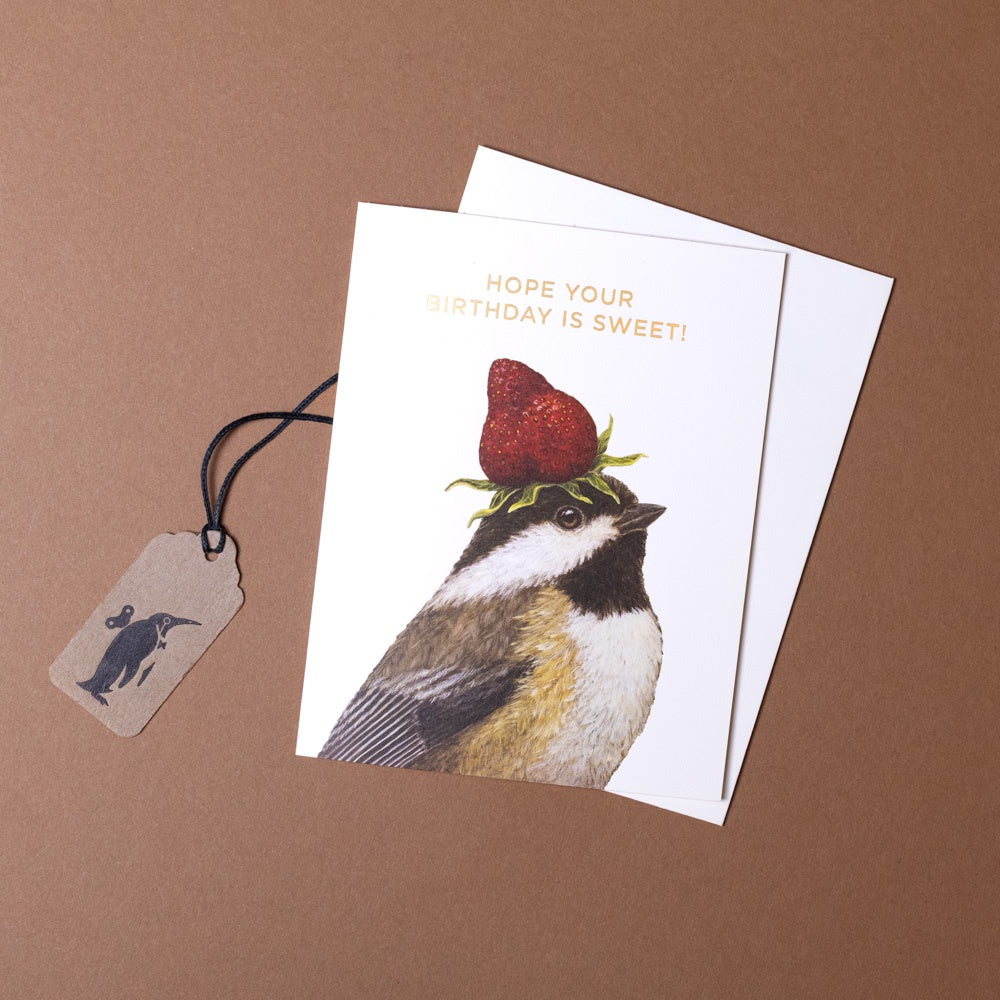 Greeting card with a bird and strawberry illustration on a brown background