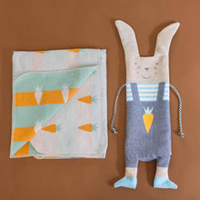 Load image into Gallery viewer, blanket-and-puppet-set-bunny-grey-overalls-with-carrot-detail-blue-white-striped-shirt-with-oatmeal-fur-blue-shoes-and-black-and-white-cord-for-arms-orange-and-green-carrot-pattern-on-oatmeal-backgrouond