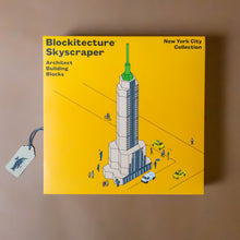 Load image into Gallery viewer, blockitecture-nyc-skyscraper-building-kit-inyellow-box-with-a-building-image-with-taxis-and-people