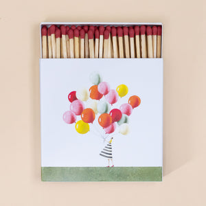 box-full-of-matches-balloon-bunch-held-by-women-in-striped-dress-with-red-tipped-matches