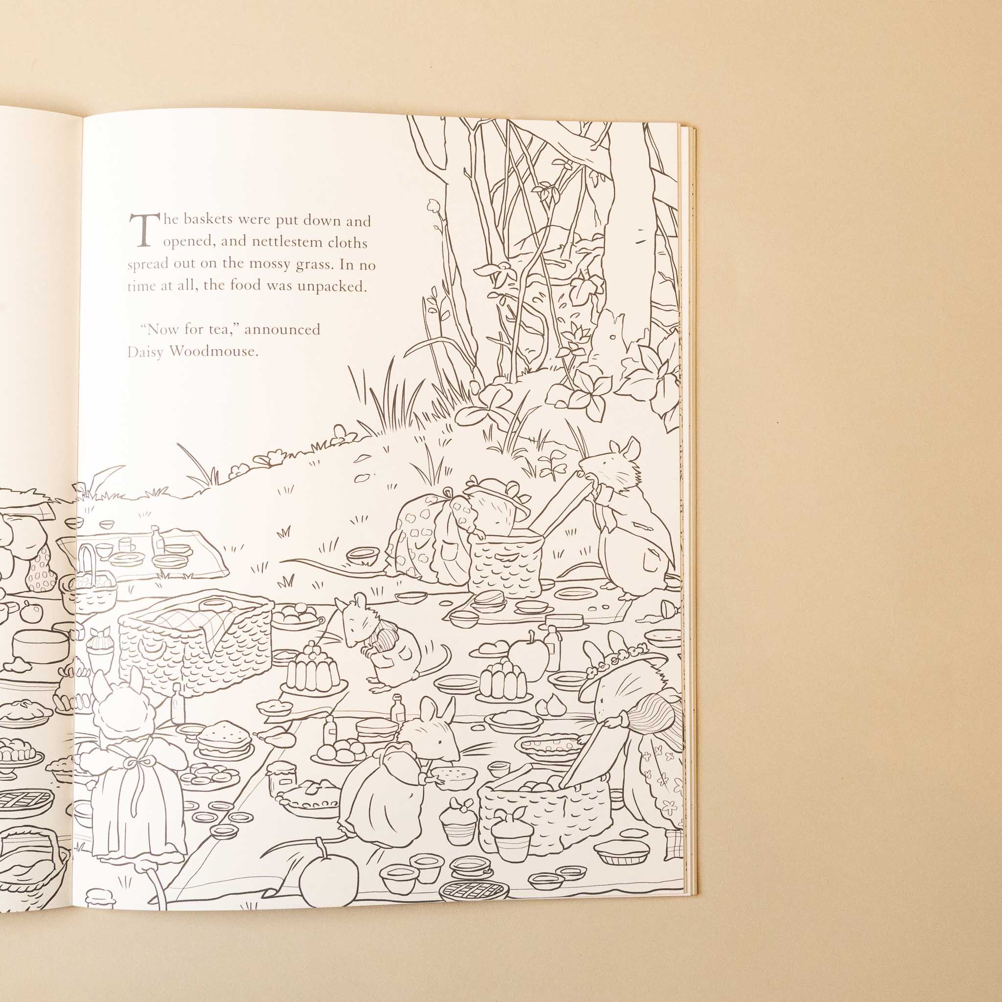 Open brambly-hedge-nature-coloring-book with a detailed illustration of a picnic scene on a beige background