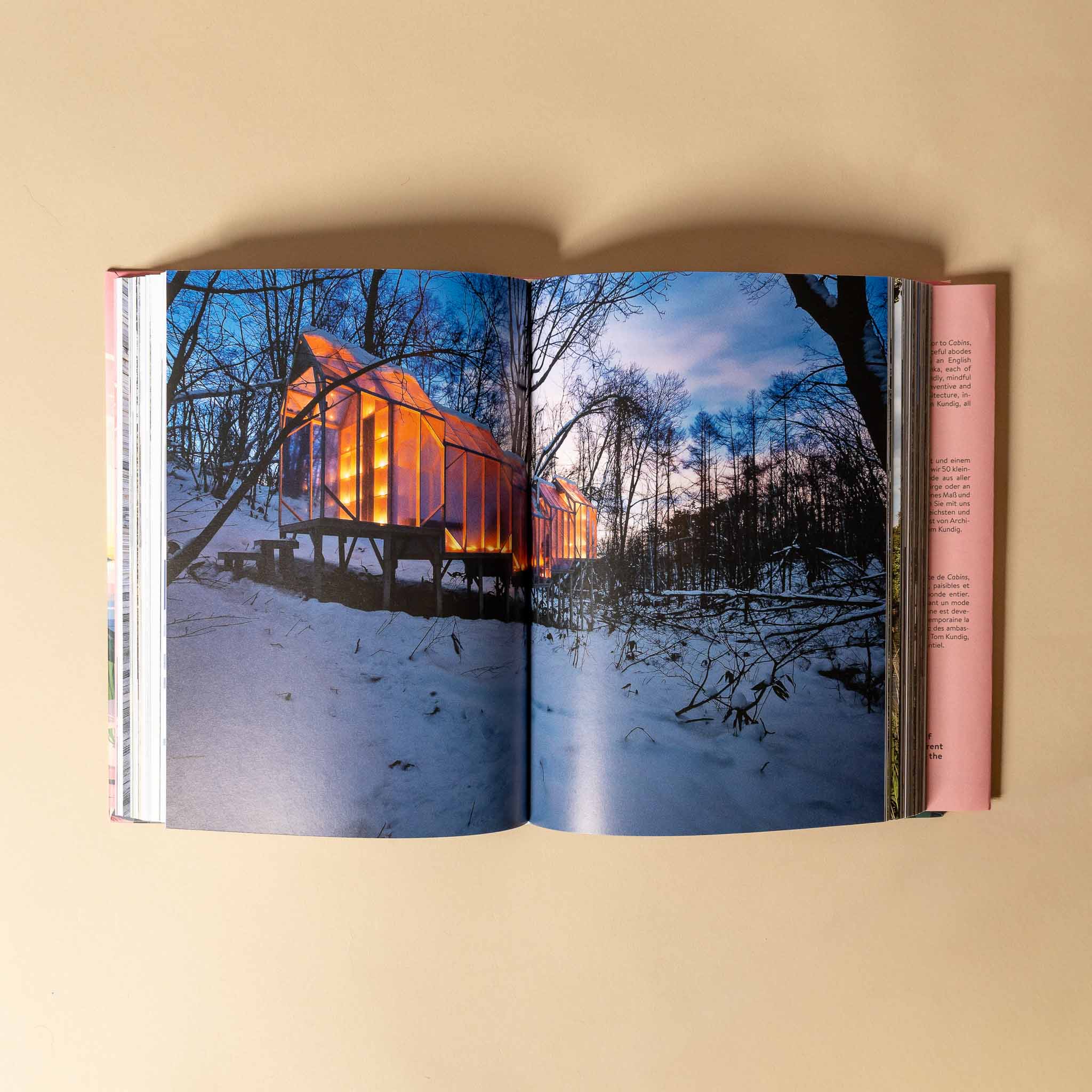 cabins Open book showing a snowy landscape with a illuminated cabin.
