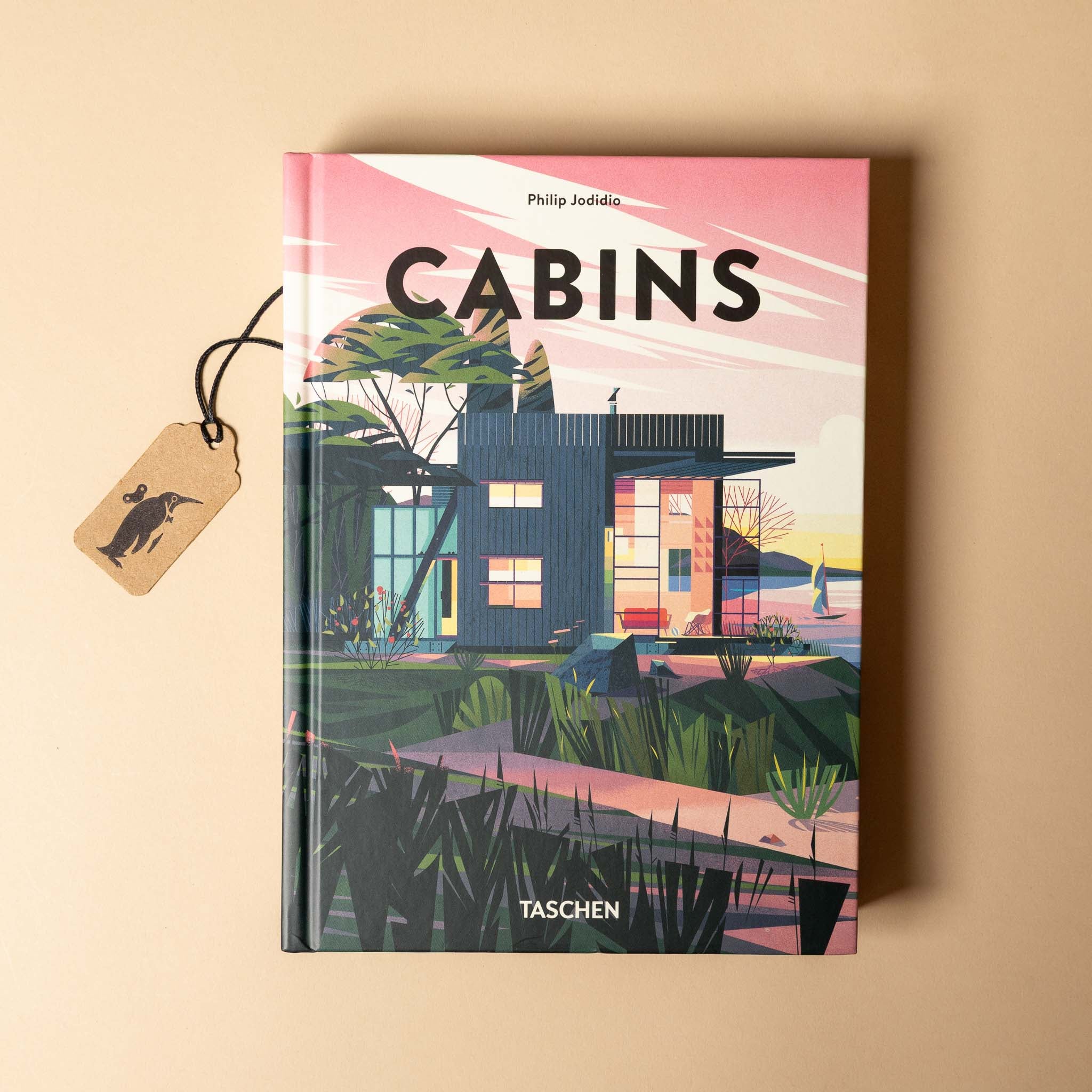 Book titled 'Cabins' by Taschen on a beige background