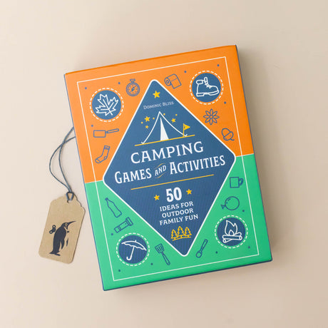camping-games-and-activities-green-and-orange-box-with-black-diamond-in-the-middle-with-hiking-boot-umbrella-campfire-and-leaves