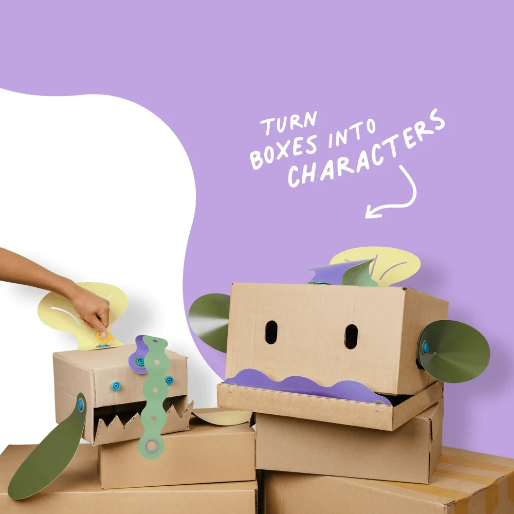 Cardboard boxes transformed into characters with additional decorations on a purple background.