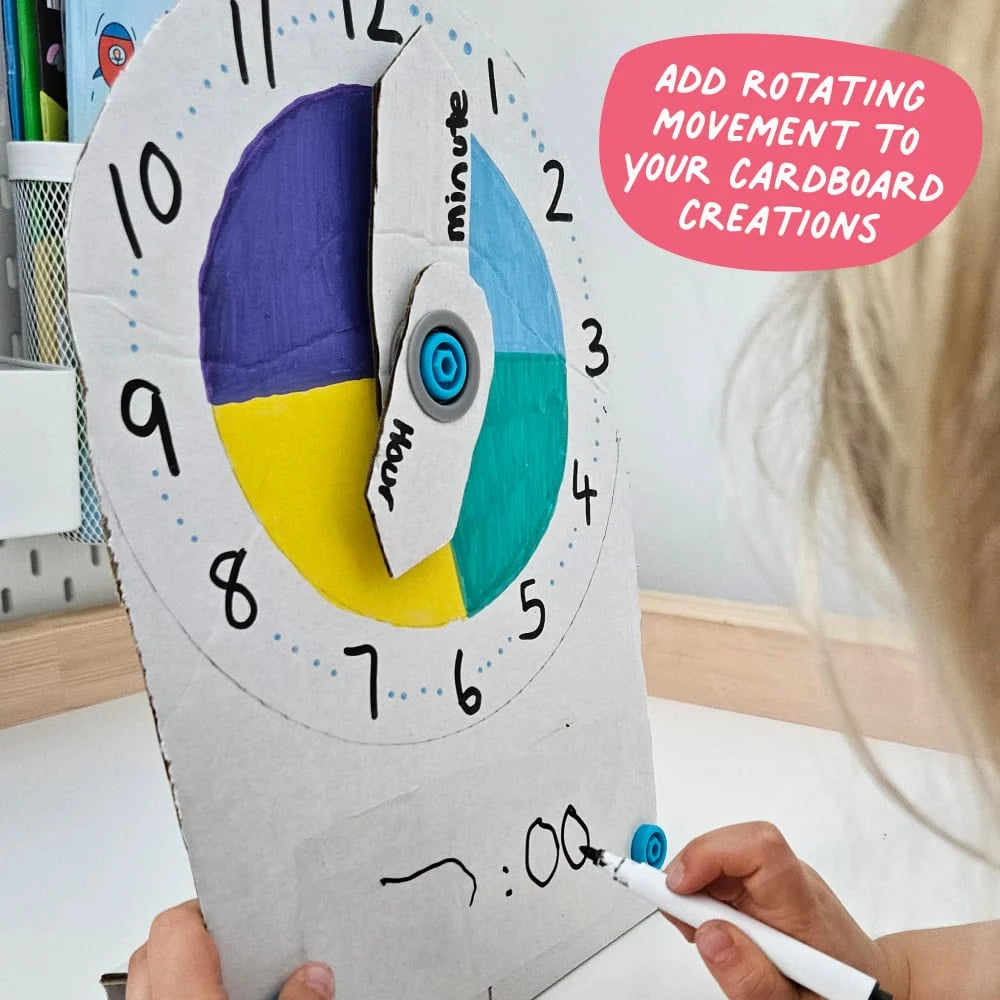 Cardboard clock with rotating hour hand, held by a child, with text 'Add rotating movement to your cardboard creations'.