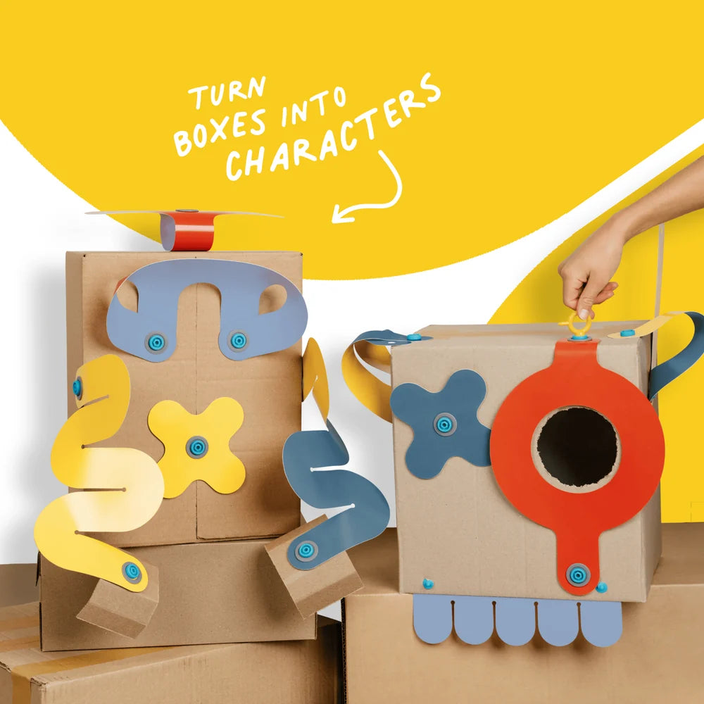Cardboard boxes transformed into colorful characters with a hand interacting with one of them against a yellow background.