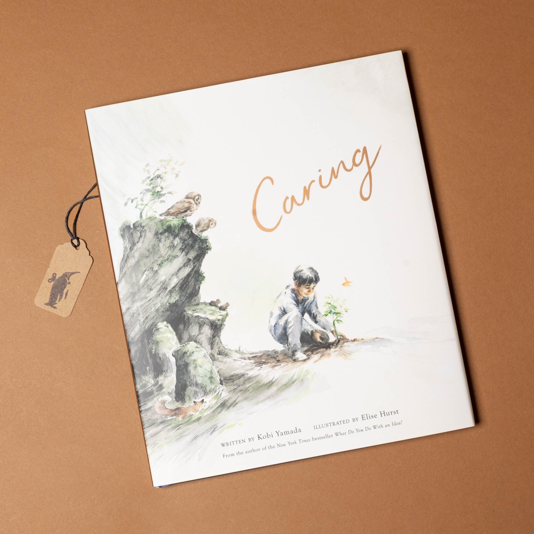 caring-book-cover-with-a-little-bow-looking-at-a-seedling