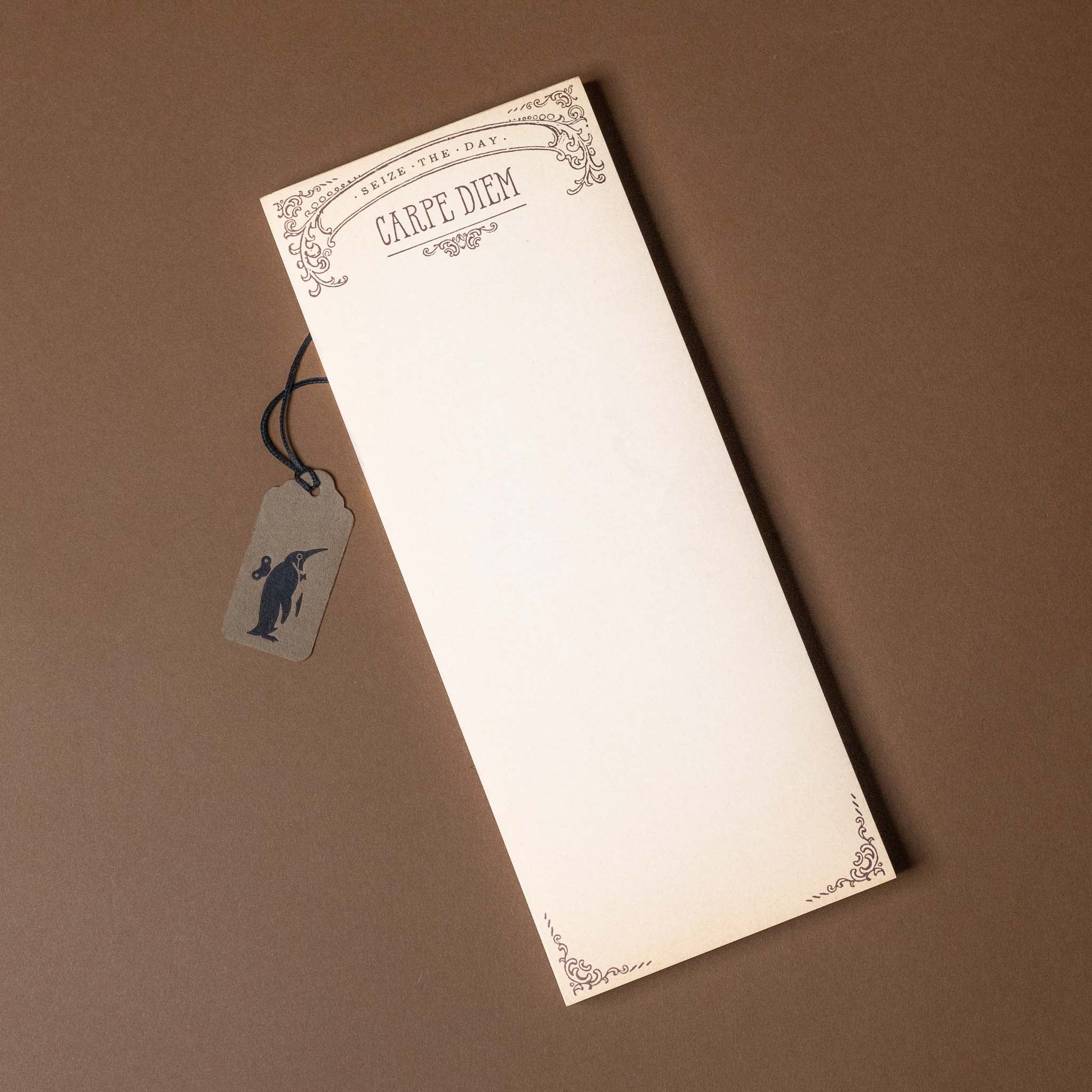 Notebook with decorative cover and tag on a brown background