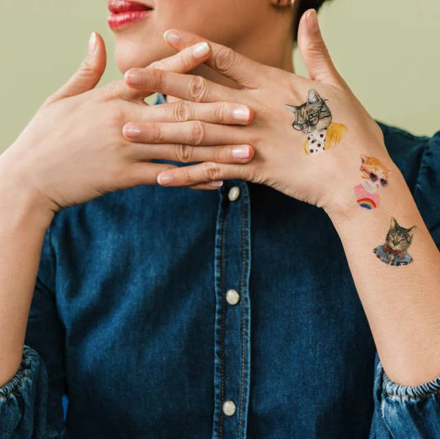 Person wearing cat-people-temporary-tattoo-sheet  on their hands and arm.